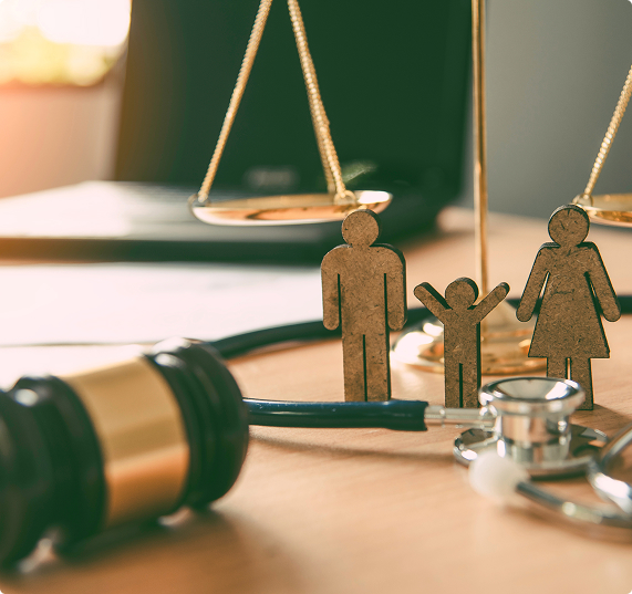 Law and family still life on a wooden table — a gavel with a stethoscope