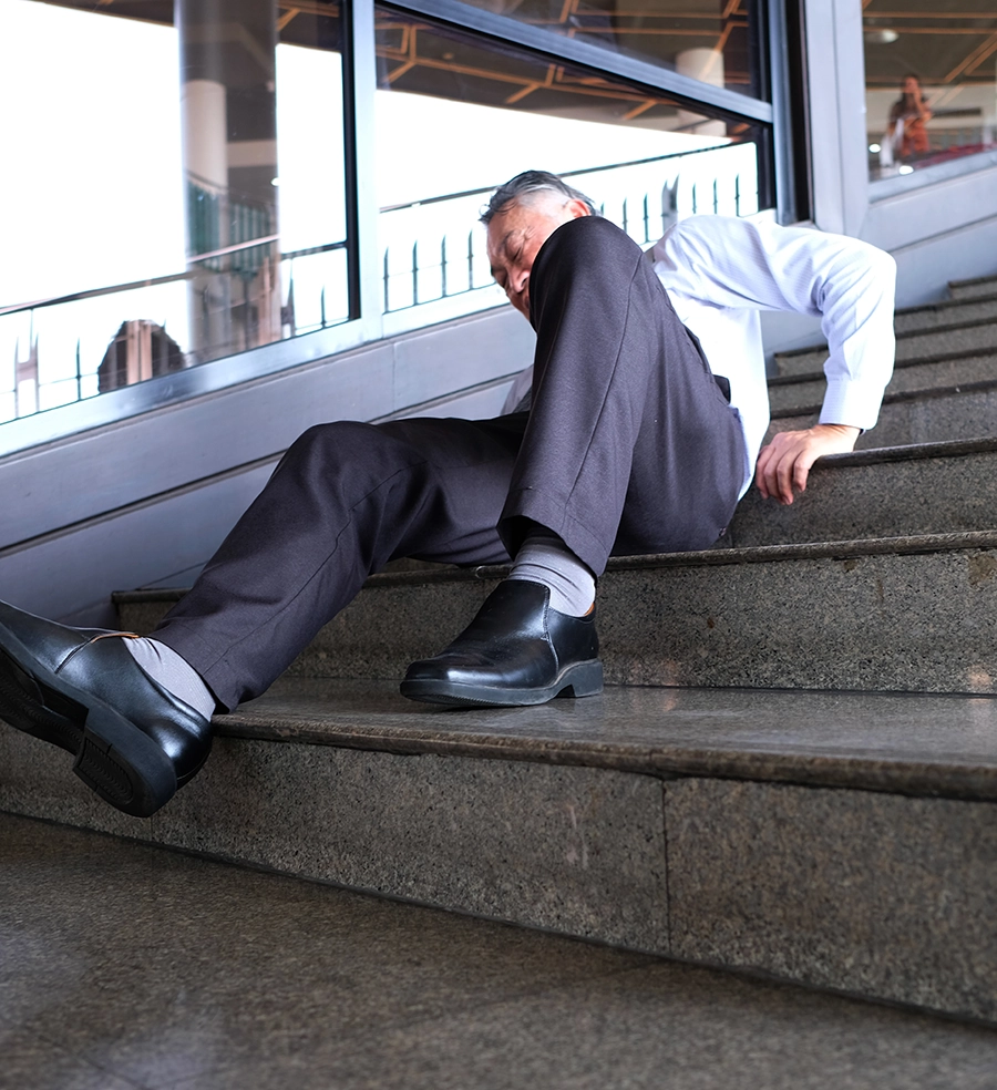 An old man falls down the stairs and is injured.